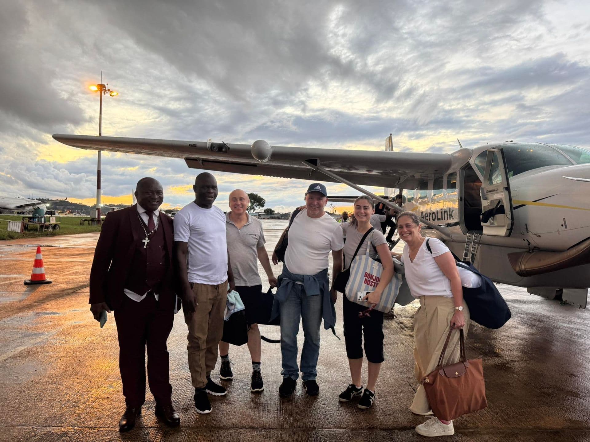 Team at small plane on tarmac